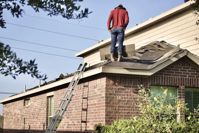 Professional roofer working on a residential roof in Townsend Harbor